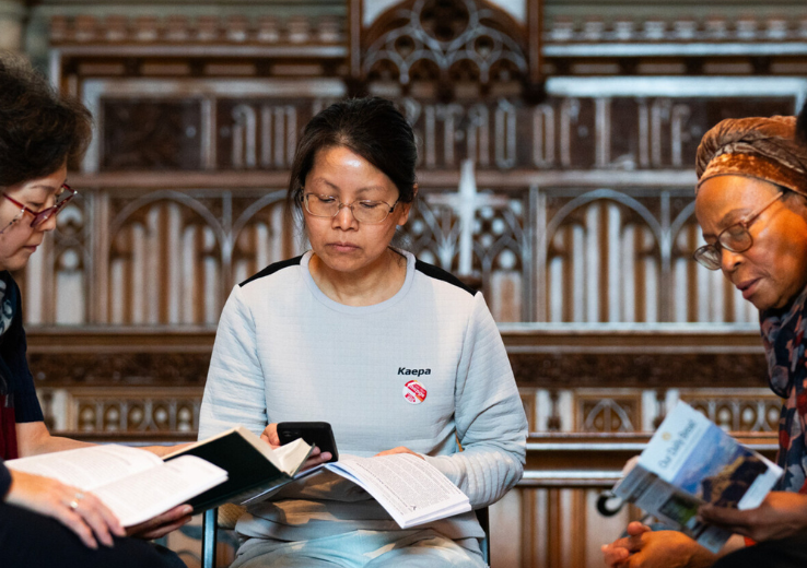 Church goers praying in a small group