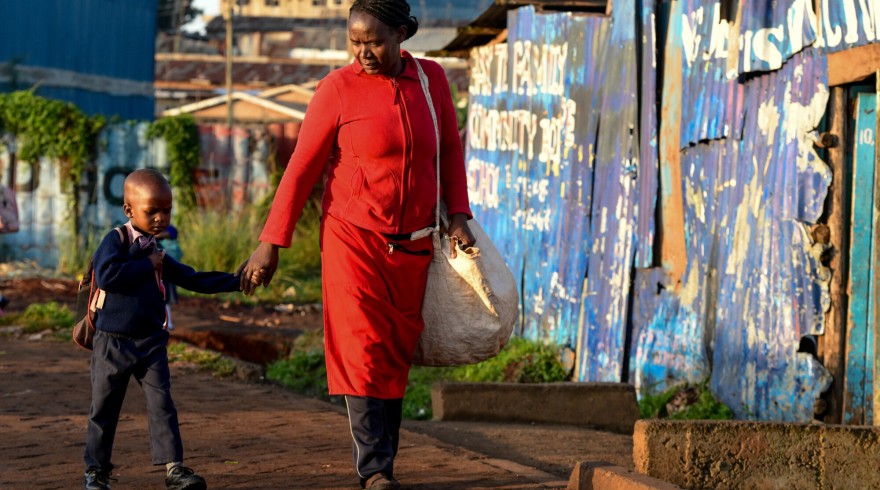  Fridah takes Quillan to school, before she sets off to the market.