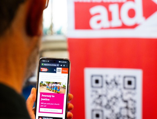 Supporter scanning Christian Aid QR code